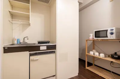 a small kitchen with a sink and a microwave at Elm\u9ad8\u7530\u99ac\u5834 in Tokyo