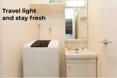 a small bathroom with a refrigerator and a sink at Nakano Apartment hotel in Tokyo