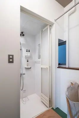 a white bathroom with a shower and a glass door at Mochida Hall 1F / Vacation STAY 80337 in Tokyo