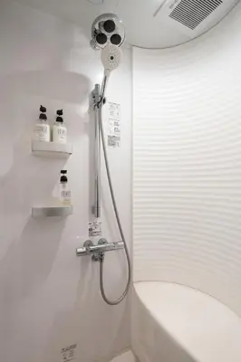 a shower in a white bathroom with a tub at Mochida Hall 1F / Vacation STAY 80337 in Tokyo