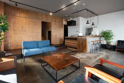 a living room with a blue couch and a table at Mochida Hall 1F / Vacation STAY 80337 in Tokyo