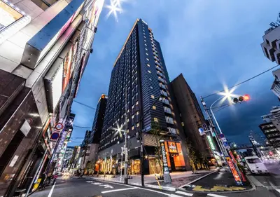 a tall building in the middle of a city at APA Hotel Higashi Shinjuku Kabukicho Tower in Tokyo