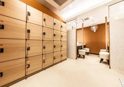 a locker room with wooden lockers and a desk at APA Hotel Higashi Shinjuku Kabukicho Tower in Tokyo