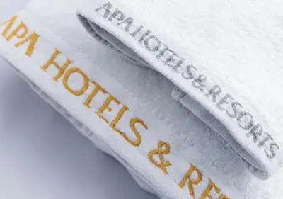 three white towels with the words new research written on them at APA Hotel Higashi Shinjuku Kabukicho Tower in Tokyo