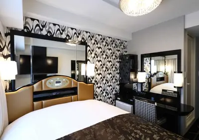 a hotel room with a bed and a mirror at APA Hotel Higashi Shinjuku Kabukicho Tower in Tokyo