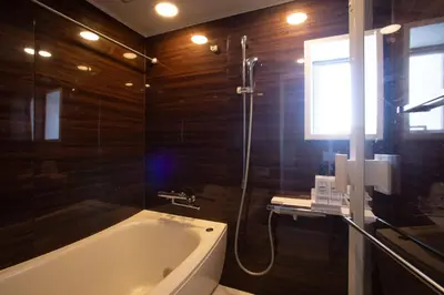 a bathroom with a bath tub and a shower at NIYS apartments 04 type in Tokyo