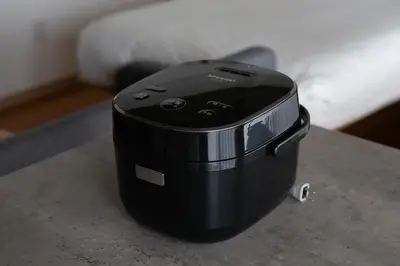 a black appliance sitting on a table next to a bed at NIYS apartments 04 type in Tokyo