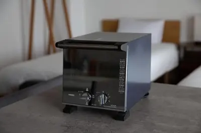a toaster oven sitting on top of a table at NIYS apartments 04 type in Tokyo