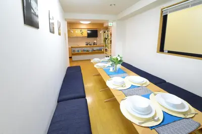 a meeting room with a long table with blue chairs at Sumida-ku - House / Vacation STAY 80342 in Tokyo