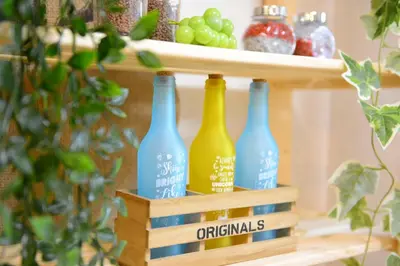 a row of wine bottles on a shelf with grapes at Sumida-ku - House / Vacation STAY 80342 in Tokyo
