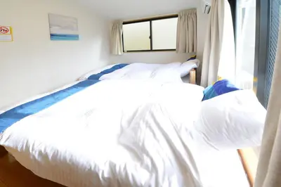 a white bed in a room with a window at Sumida-ku - House / Vacation STAY 80342 in Tokyo