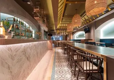 a bar with chairs and a long counter in a restaurant at Galois Hotel Shinokubo in Tokyo