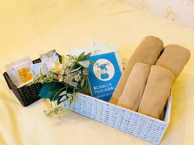 a basket with a bunch of products on a bed at Tabist Hotel Aurora Ikebukuro in Tokyo
