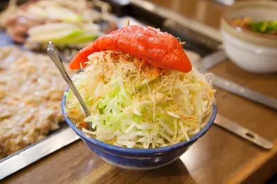 a blue bowl of food with cabbage and peppers at Tabist Hotel Aurora Ikebukuro in Tokyo