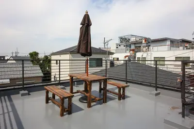 a table and benches on top of a roof at \u58a8\u75304\u4e01\u76ee in Tokyo