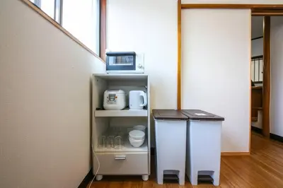 a small refrigerator with a microwave on top of it at \u58a8\u75304\u4e01\u76ee in Tokyo