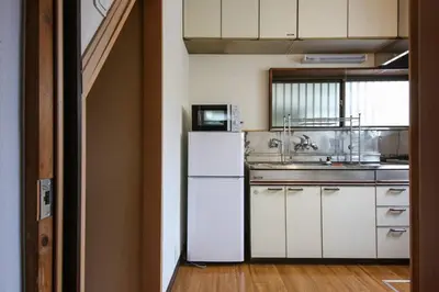 a kitchen with a white refrigerator and a sink at \u58a8\u75304\u4e01\u76ee in Tokyo