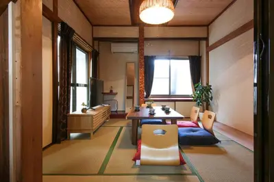 a living room with a table and chairs and a window at \u58a8\u75304\u4e01\u76ee in Tokyo