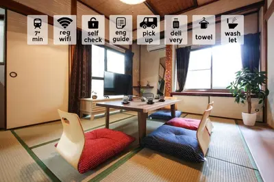 a living room with a table and two chairs at \u58a8\u75304\u4e01\u76ee in Tokyo