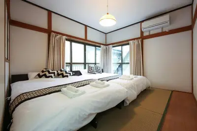a large bed in a room with a large window at \u58a8\u75304\u4e01\u76ee in Tokyo