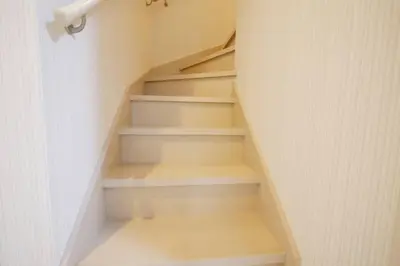 a staircase in a house with white walls at \u30a2\u30f3\u30c9\u30b9\u30c6\u30a4\u9ad8\u78022\u4e01\u76ee in Tokyo