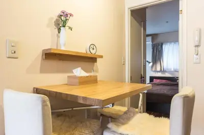 a dining room with a table and two chairs at \u30a2\u30f3\u30c9\u30b9\u30c6\u30a4\u767e\u4eba\u753a2\u4e01\u76eeA in Tokyo