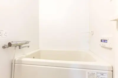 a white bath tub in a bathroom with a sink at \u30a2\u30f3\u30c9\u30b9\u30c6\u30a4\u767e\u4eba\u753a2\u4e01\u76eeA in Tokyo