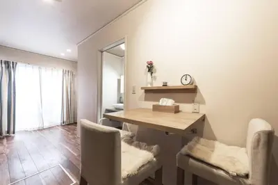 a dining room with a table and two chairs at \u30a2\u30f3\u30c9\u30b9\u30c6\u30a4\u767e\u4eba\u753a2\u4e01\u76eeA in Tokyo