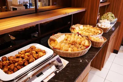 a buffet with several different types of food on a counter at Super Hotel JR Ueno Iriyaguchi in Tokyo