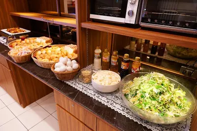 a kitchen counter with bowls of vegetables and other foods at Super Hotel JR Ueno Iriyaguchi in Tokyo