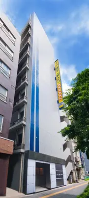 a building with a blue stripe on the side of it at Super Hotel JR Ueno Iriyaguchi in Tokyo