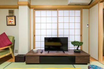 a living room with a flat screen tv on a table at \u30a2\u30f3\u30c9\u30b9\u30c6\u30a4\u6edd\u91ce\u5ddd3\u4e01\u76ee in Tokyo