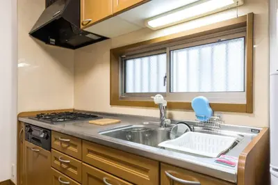 a kitchen with a sink and a stove and a window at \u30a2\u30f3\u30c9\u30b9\u30c6\u30a4\u6edd\u91ce\u5ddd3\u4e01\u76ee in Tokyo