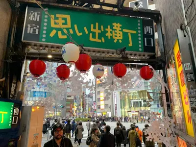 a crowd of people walking in a street with lanterns at \u30a2\u30f3\u30c9\u30b9\u30c6\u30a4\u672c\u753a5\u4e01\u76ee in Tokyo