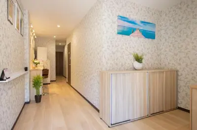 a living room with a counter with a vase on it at My Home in Tokyo in Tokyo