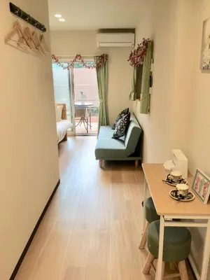 a small living room with a table and a couch at My Home in Tokyo in Tokyo