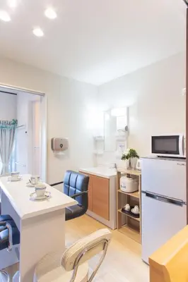a kitchen with a table and a refrigerator at My Home in Tokyo in Tokyo