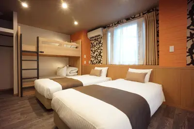 two beds in a room with two bunk beds at WIRES HOTEL James zaka in Tokyo