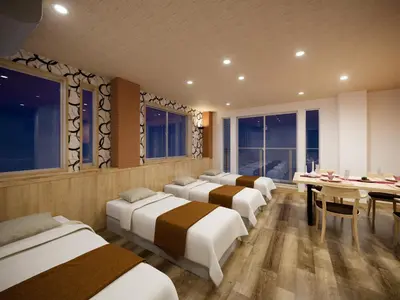 a row of beds in a room with a table and chairs at WIRES HOTEL James zaka in Tokyo
