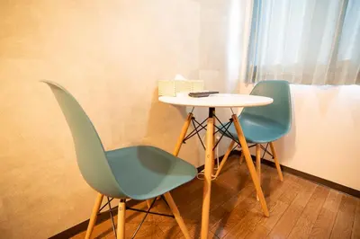 two chairs and a table and a table and chairs at Vail sta Takenotsuka in Tokyo