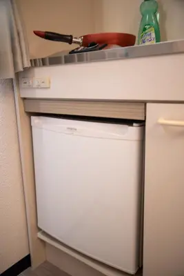 a white dishwasher in a kitchen next to a counter at Vail sta Takenotsuka in Tokyo