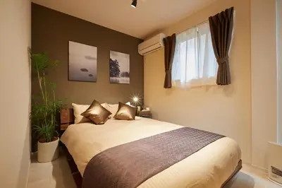a bedroom with a bed and a window at Frieden Haus in Tokyo