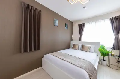a bedroom with a white bed and a window at Frieden Haus in Tokyo