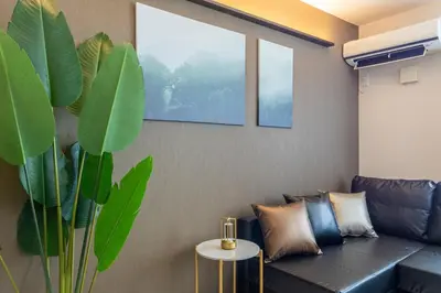 a living room with a couch and a plant at Frieden Haus in Tokyo