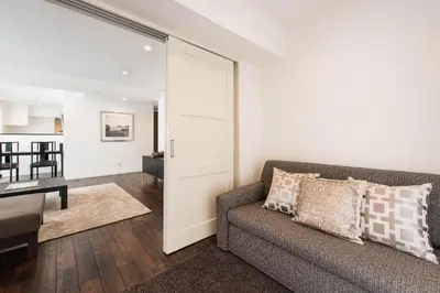 a living room with a couch and a table at NC Square Shinjuku -All Suite Residence- in Tokyo
