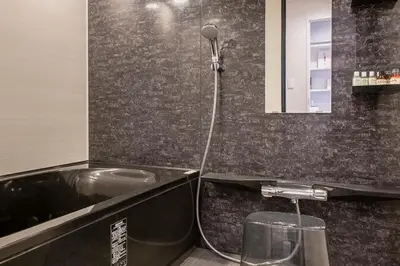 a bathroom with a tub and a sink and a shower at NC Square Shinjuku -All Suite Residence- in Tokyo