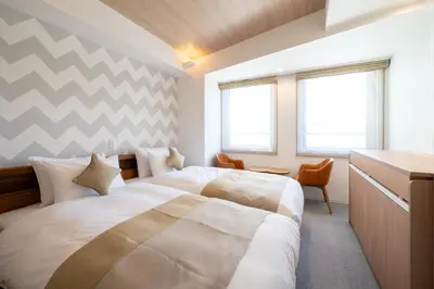 a bedroom with a large bed and a desk at Stay SAKURA Tokyo ASAKUSA ART DECO HOTEL in Tokyo