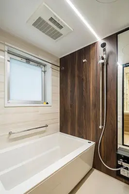 a bathroom with a white tub and a window at Section L Ginza East in Tokyo