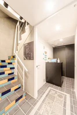 a lobby with stairs and a desk in a building at Space F Yoyogi in Tokyo
