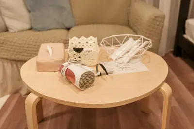 a small table with items on it next to a couch at Space F Yoyogi in Tokyo
